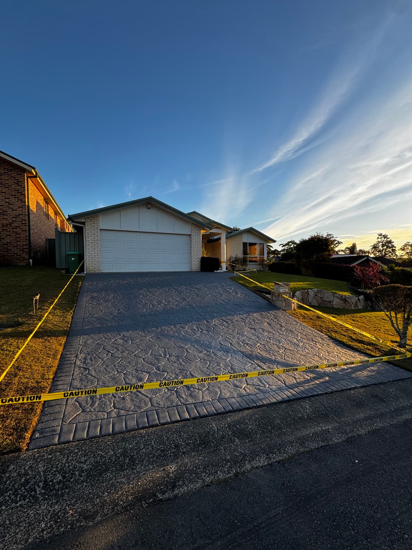 Freshly colour-sealed stencil concrete driveway on the Central Coast